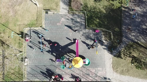 aerial view of children playground. kids are playing game at the sunset.