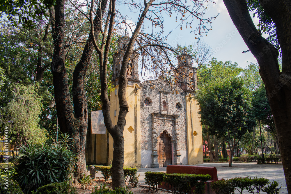 Old Mexican Church surrounded by trees in Coyoacan