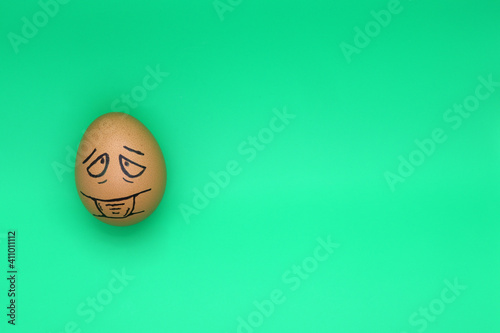 Egg in a mask on a solid background, the coronavirus virus
