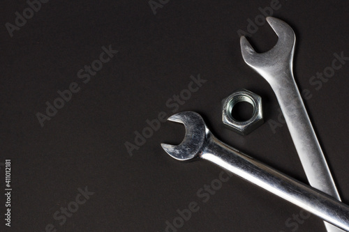spanners and screw-nut on black background