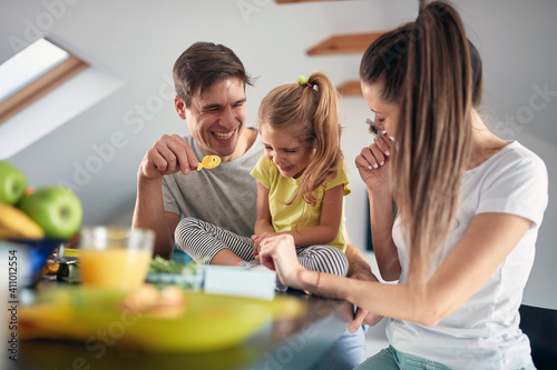 A young happy family having a good time after a breakfast at home together. Family, breakfast, together, home