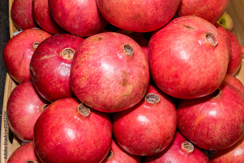 Pomegranate garnet fruit background pattern. Fresh raw organic garnet fruit pile texture background. 