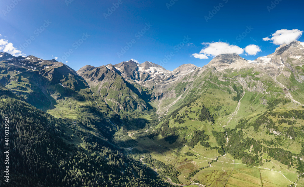 Aerial drone shot of Grossglockner mountain range valley in summer in Austria