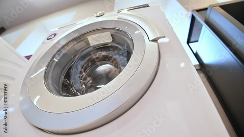 rows of washing machines in domestic appliances store