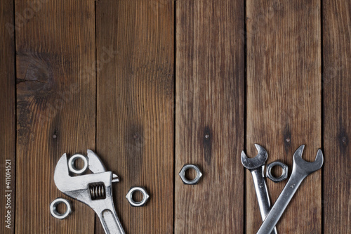 Set of wrenches on a wooden textured Background