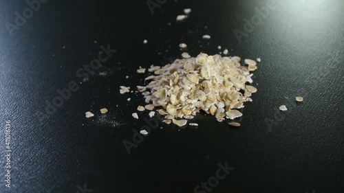 A small portion of oatmeal rotating on a black background, closeup shot