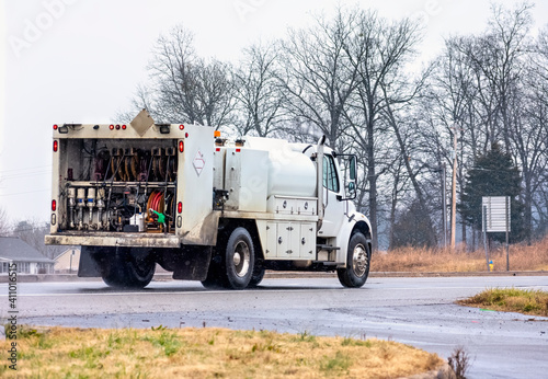 Lubrication Service Truck Drives In Rain and Snow