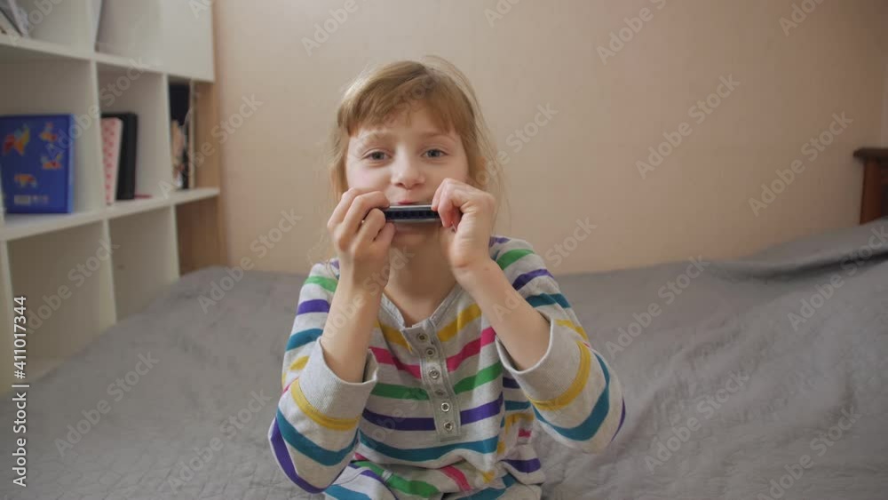 Girl playing harmonica home interior