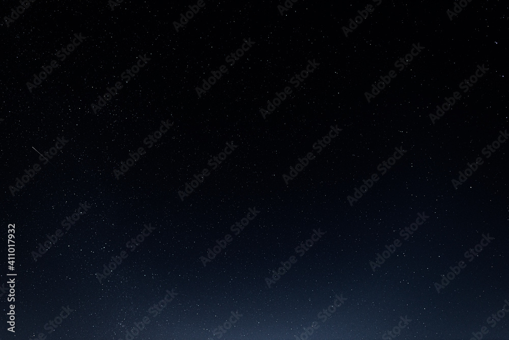 A starry sky with many stars and a flying meteor
