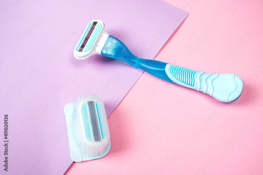 Women razor with replaceable cartridge isolated on a pink background. Close-up. Beauty concept. Women razor with replaceable cartridge isolated on a pink background. Close-up. Beauty concept.