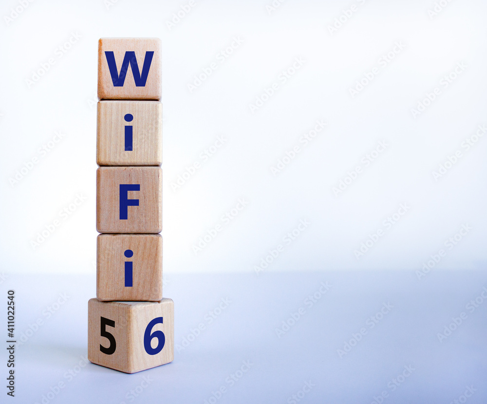 WiFi 5 or 6 symbol. Turned a wooden cube and changed the words WiFi 5 to WiFi 6. Beautiful white background, copy space. Business, technology and WiFi 5 to WiFi 6 concept. WiFi 5 or 6 symbol. Turned a wooden cube and changed the words WiFi 5 to WiFi 6. Beautiful white background, copy space. Business, technology and WiFi 5 to WiFi 6 concept.