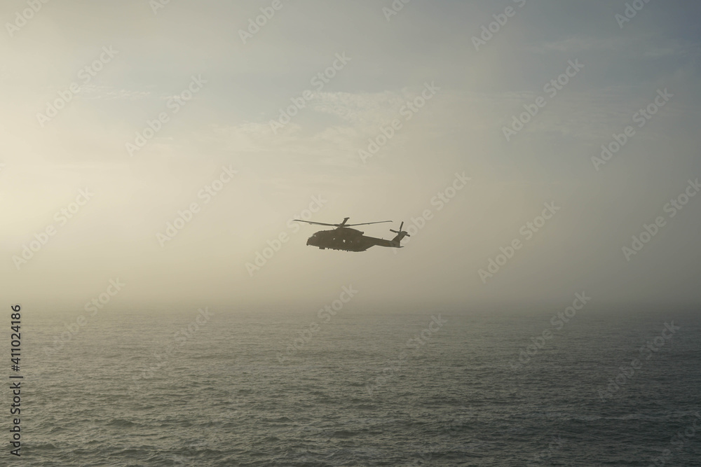 helicopter in the middle of the sea with fog