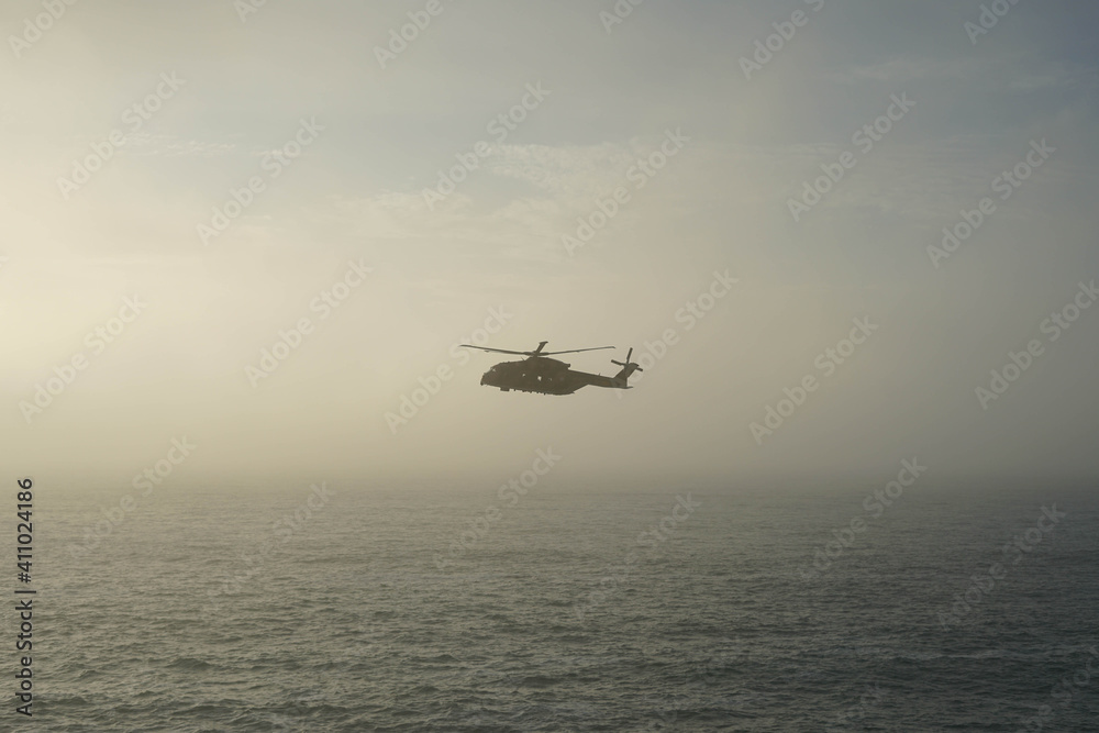 helicopter in the middle of the sea with fog helicopter in the middle of the sea with fog