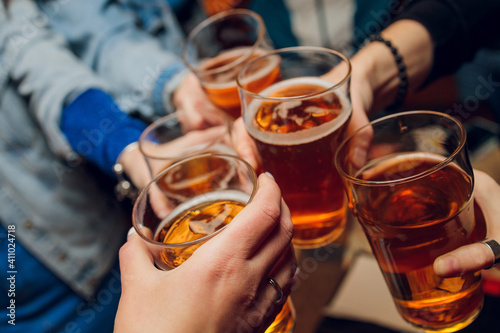 Clinking glasses with alcohol and toasting, party.