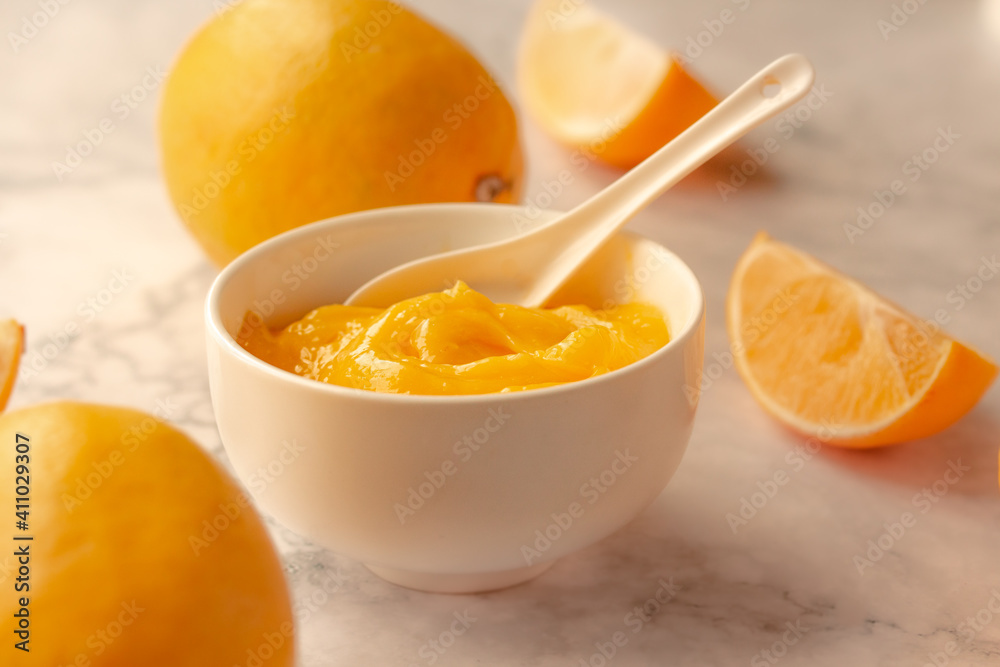 Homemade fresh pudding or tangy lemon curd in a white bowl.Selective focus Homemade fresh pudding or tangy lemon curd in a white bowl.Selective focus