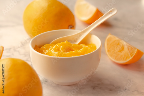 Homemade fresh pudding or tangy lemon curd in a white bowl.Selective focus