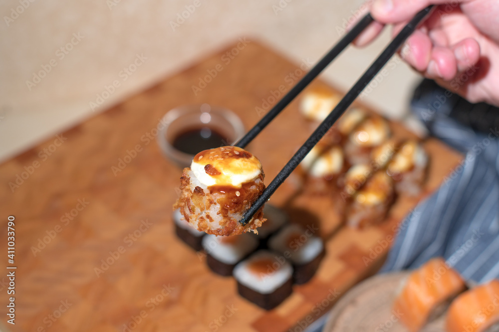 Sushi set. Hand with chopsticks Sushi set. Hand with chopsticks