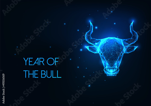 Futuristic glowing low polygonal bull head, ox, taurus horoscope sign isolated on dark blue