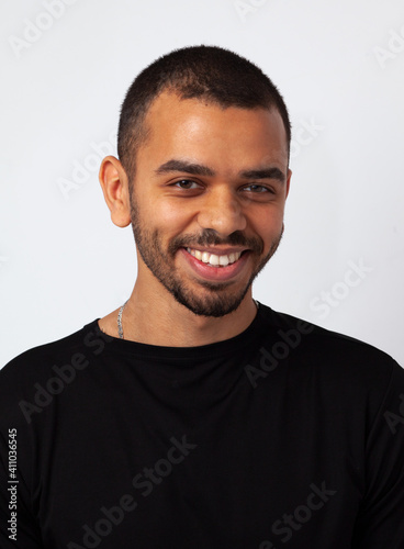 young simple african guys with sincerly smile, in black sweathshot isolated on studio background, close up portrait photo