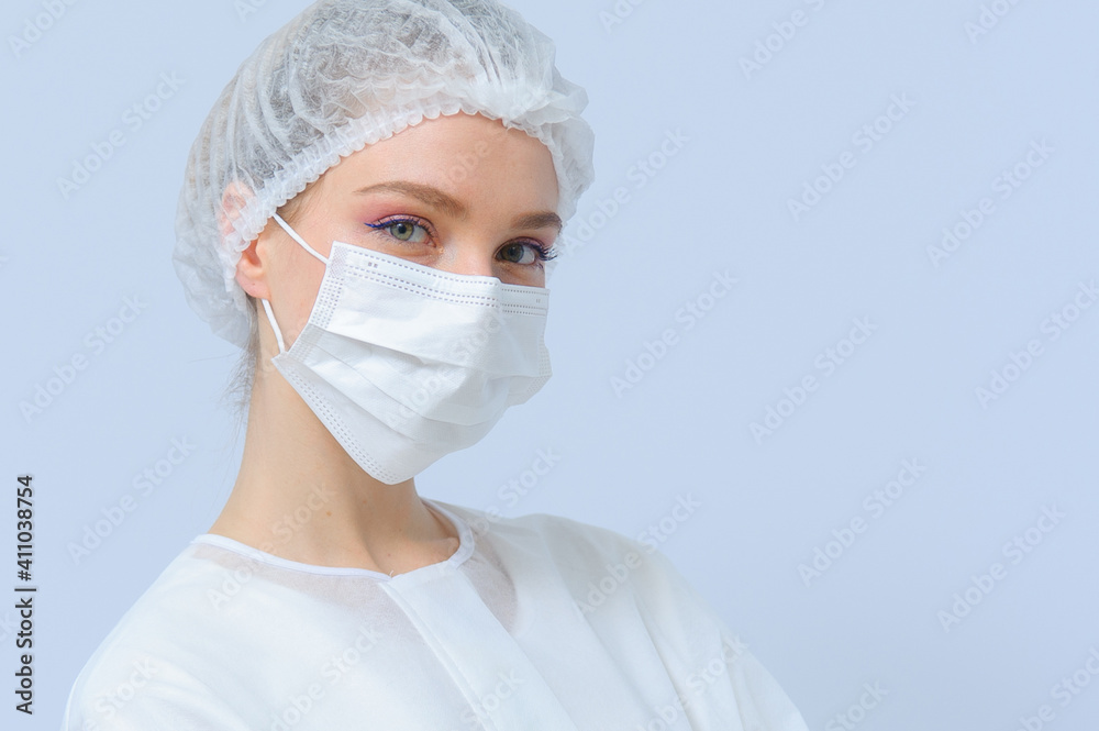 Portrait of a female doctor or nurse wearing medical cap and face mask Portrait of a female doctor or nurse wearing medical cap and face mask