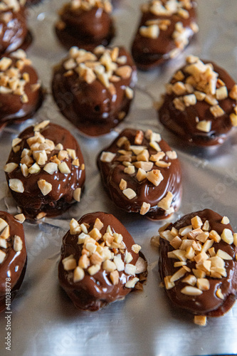 Dried apricots in chocolate sprinkled with nuts.