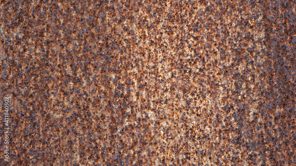 A rusty metal fence exposed to the weather. A rusty metal fence exposed to the weather.