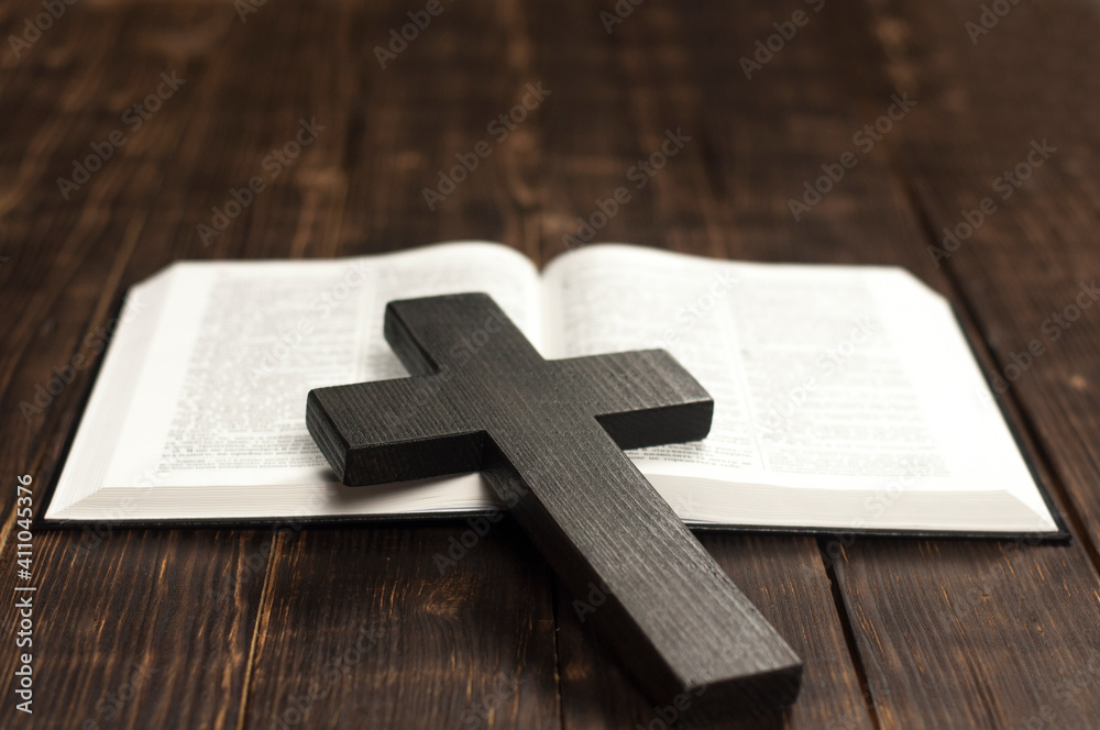 Cross. Open Bible. Bible book on a wooden table. Love god. Wooden cross of Jesus. Red heart. The concept of love for God's Word.	