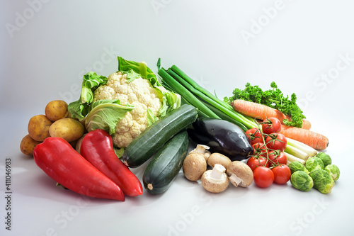 Healthy fresh vegetables of different varieties on a light gray background, diet food concept for fitness and lose weight, copy space