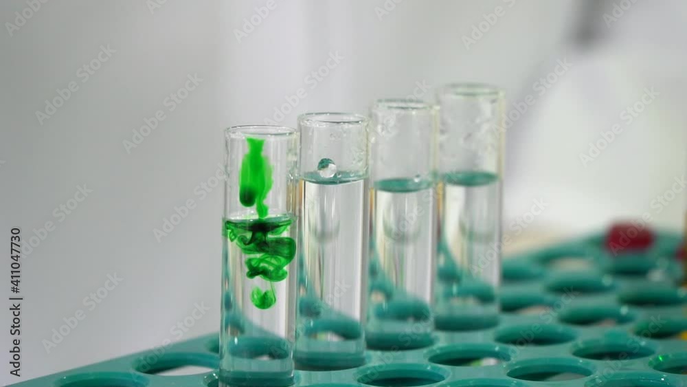 mixing chemicals in laboratory, testing and dripping test fluid in close up, test tubes mixing chemicals in laboratory, testing and dripping test fluid in close up, test tubes