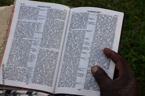 Fotografie Swahili Bible with hand and finger on the bible from an african men