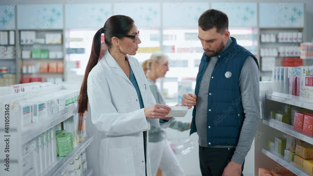 Pharmacy: Professional Female Pharmacist Helping Handsome Male Customer with Medicine Recommendation, Advice, Talking. Drugstore with Full of Drugs, Pills, Health Care, Sport Supplement Products Pharmacy: Professional Female Pharmacist Helping Handsome Male Customer with Medicine Recommendation, Advice, Talking. Drugstore with Full of Drugs, Pills, Health Care, Sport Supplement Products