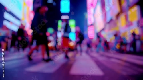 New York City colorful Times Square at night, street, anonymous people walk, motion view