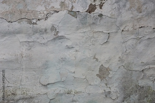 gray white texture of shabby plaster with cracks on an old concrete wall