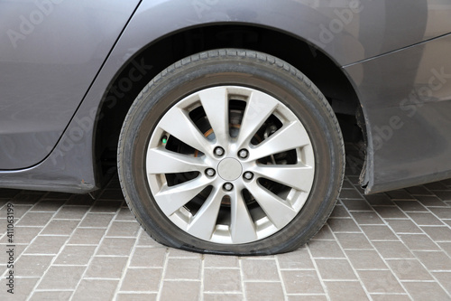 Car flat tire on tiled floor