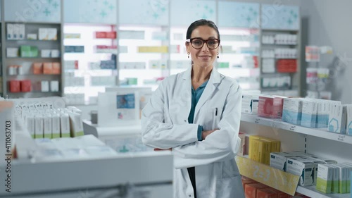 Wallpaper Mural Pharmacy: Portrait of Beautiful Professional Caucasian Female Pharmacist Wearing Glasses, Crosses Arms and Looks at Camera Smiling Charmingly. Drugstore Store with Shelves Health Care Products Torontodigital.ca