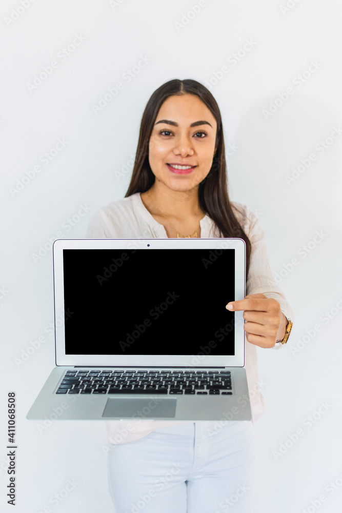 Young woman points her finger at the screen of her laptop Young woman points her finger at the screen of her laptop