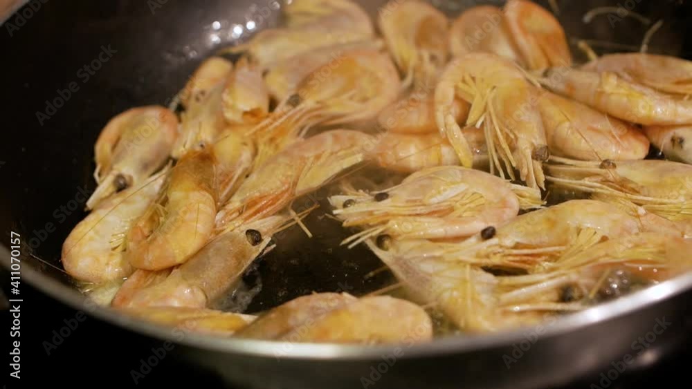 Frying shrimps in a pan with oil and spices slow motion Frying shrimps in a pan with oil and spices slow motion