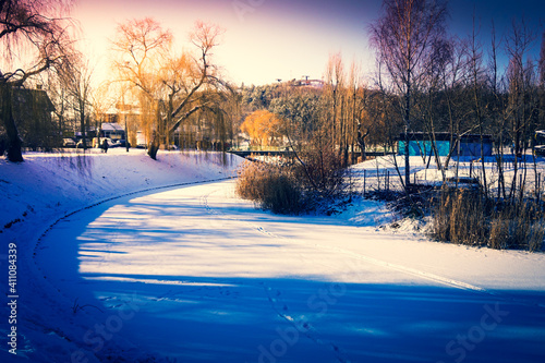 Frozen pond covered with snow in winter photo