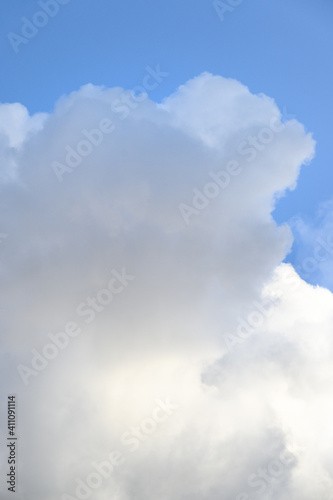 Late afternoon cloudscape  glowing clouds against a blue sky  as a nature background 