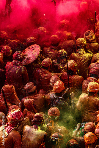 Barsana, Uttar Pradesh, India February 6 2021: People celebrate the traditional and a ritualistic Holi at Radharani temple in Barsana. Holi is the most celebrated and colorful festival in India. photo