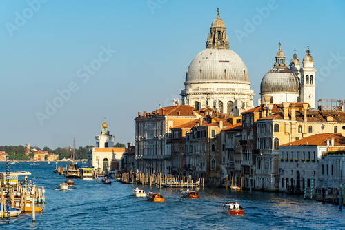 Beautiful Venetian cityscape at sunset, with a view on the Grand Canal and the domes of Santa Maria della Salute, Venice, Italy