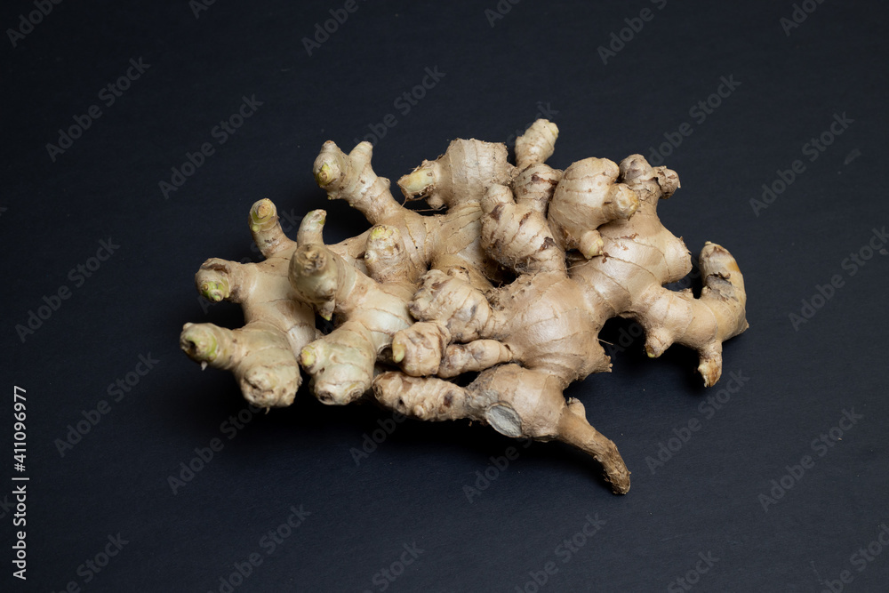 Fresh organic ginger isolated on black background. It is widely used as a spice and a folk medicine Fresh organic ginger isolated on black background. It is widely used as a spice and a folk medicine