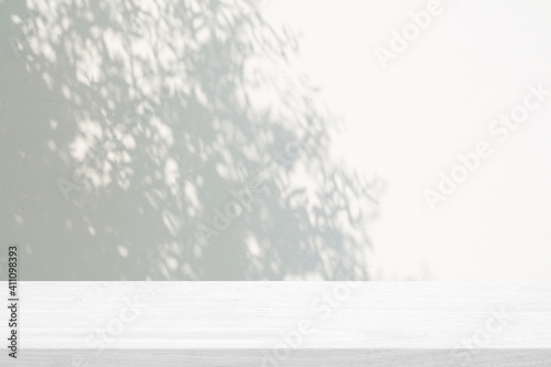 White Wood Table with Tree Shadow on Concrete Wall Texture Background, Suitable for Product Presentation Backdrop, Display, and Mock up.