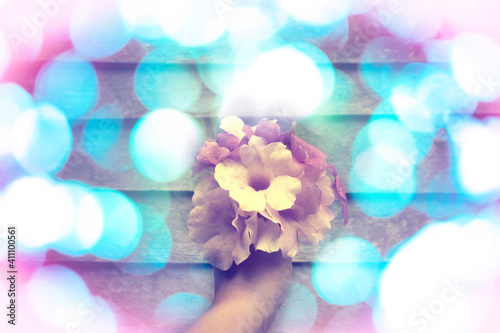 Beautiful  violet flower  bouquets on hand  with  colorful bokeh  background