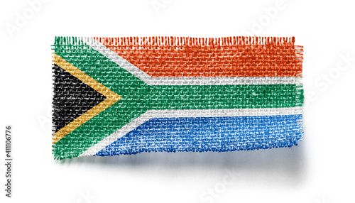 South Africa flag on a piece of cloth on a white background