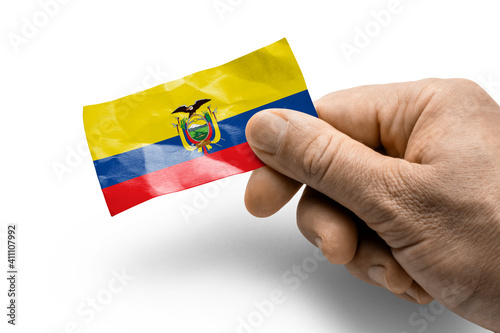 Hand holding a card with a national flag the Ecuador
