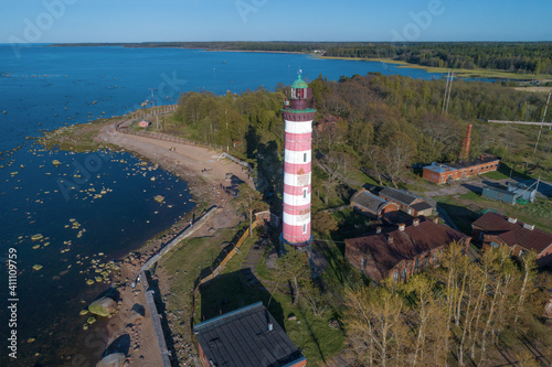 View of the Shepelevsky lighthouse on the shore of the Finnish Bay on a May afternoon (aerial photography). Leningrad region, Russia
