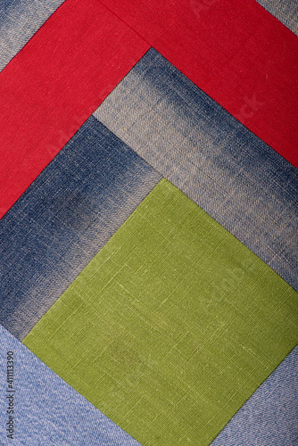 Dark blue denim denim background sewn from patches background, detailed texture with vignette
