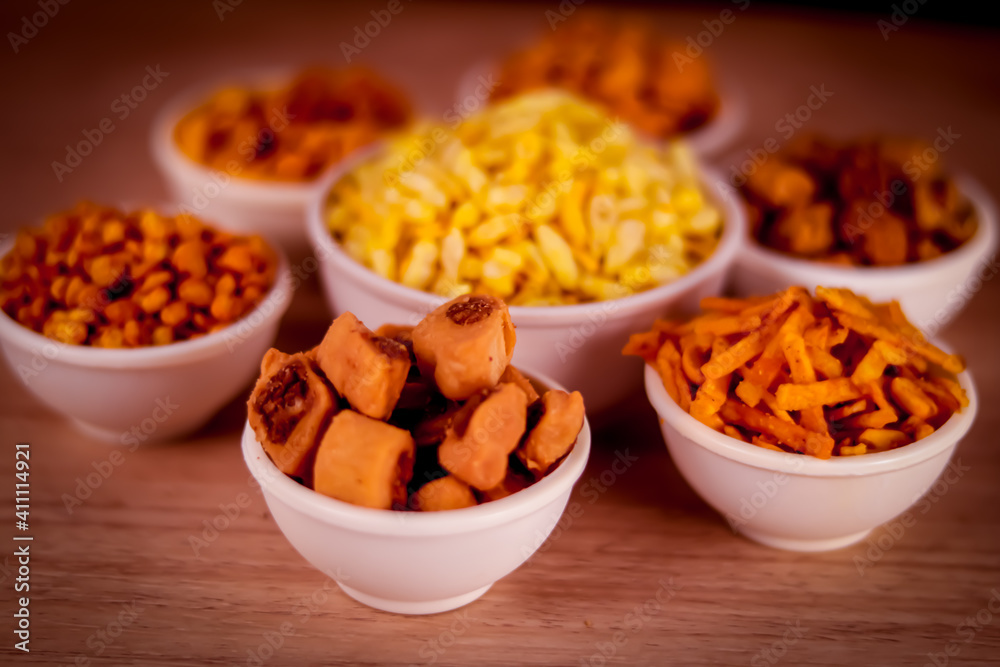 indian namkeen on wooden table,Indian Namkeen or snacks in white bowl on wooden background, close up of indian Namkeen snacks beautiful footage,Sev murmura,chanadal,shing bhujia,mix chavana indian namkeen on wooden table,Indian Namkeen or snacks in white bowl on wooden background, close up of indian Namkeen snacks beautiful footage,Sev murmura,chanadal,shing bhujia,mix chavana