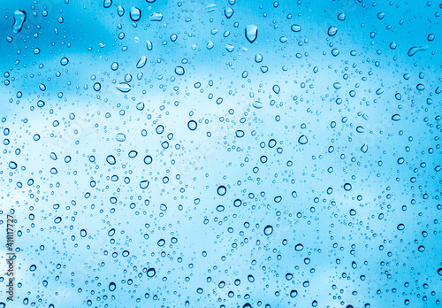 Water drops or Rain drops on glass with blue filter